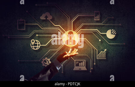 Close of businessman hand showing at user interface glowing on wall Stock Photo