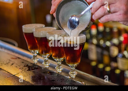 San Francisco, USA - May 2, 2014: Irish Coffee drinks being made on the bar counter at the famous Buena Vista cafe where it was invented, near the Pow Stock Photo