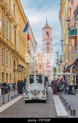 Nice, France - April 21, 2016: Narrow streets the the Old Town, Vieille Ville and a tourist train driving through
