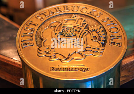 Seattle, USA - February 26, 2017: Bronze logo at the original Starbucks store. First Starbucks coffee store opened in 1971 at Pike Place Public market Stock Photo