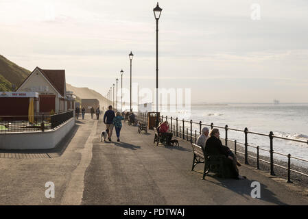 Tourists enjoying a beautiful spring afternoon on the promenade at Saltburn-by-the-sea, North Yorkshire, England. Stock Photo