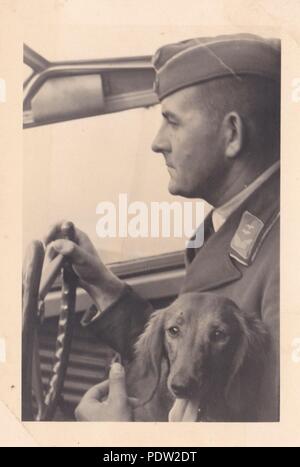 Image from the photo album of Oberfeldwebel Karl Gendner of 1. Staffel, Kampfgeschwader 40: Oberleutnant Leo Drengk, Staffelkapitän of 3./KGzbV 9, at the controls of a Junkers Ju 52/3m transport aircraft of that unit, flying out of Tutow in September 1939, during the Poland campaign. The dachshund was the Staffel mascot and the subject of the Staffel badge. Gendner was a pilot with 3./KGzbV 9 at this time. Stock Photo