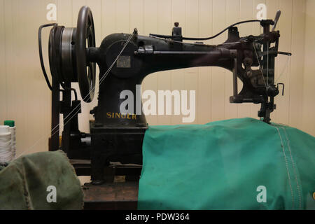 National Waterways Museum, Ellesmere Port, Cheshire, CH65 4FW, UK. Aug- 02 2018 - Old Singer Sewing Machine with Can-vas Sail Sheet being worked on. Stock Photo