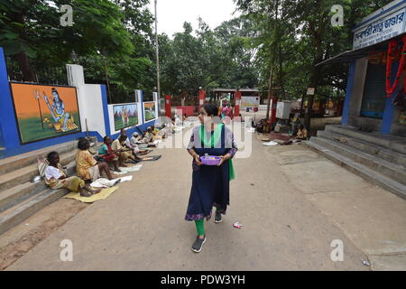 A hindu lady is returning after performing Kali puja from the Kankalitala mandir near Prantik railway station in the district Birbhum, West Bengal, In Stock Photo