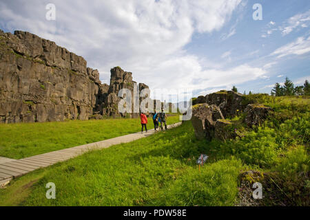 Hikers wander the famous Almannagja Gorge, in Thingvellir National Park, in south Iceland. Stock Photo