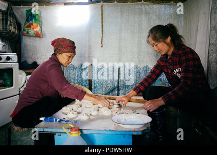 Woman preparing dumplings in traditional Kyrgiz Yurt Stock Photo
