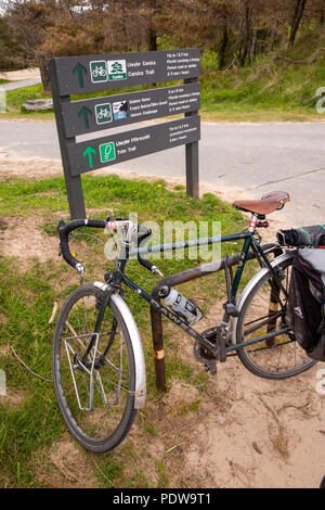 UK, Wales, Anglesey, Newborough Forest, Bicycle beside walking and cycling trail signs Stock Photo