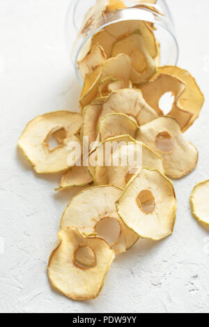 Apple dehydrated fruit chips on white background, copy space, healthy vegan snack. Stock Photo