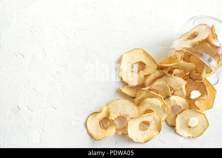 Apple dehydrated fruit chips on white background, copy space, healthy vegan snack. Stock Photo