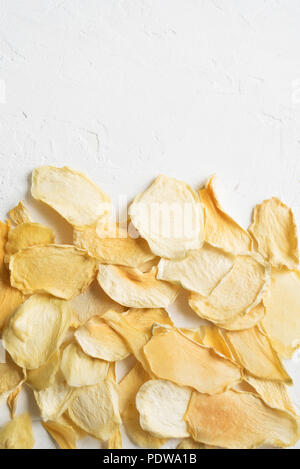 Mango or melon  fruit dehydrated chips on white background, copy space, healthy vegan snack. Stock Photo