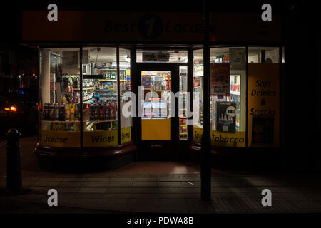 Off license and Convenience store, Winchester Street, Salisbury, Wiltshire, England at night Stock Photo