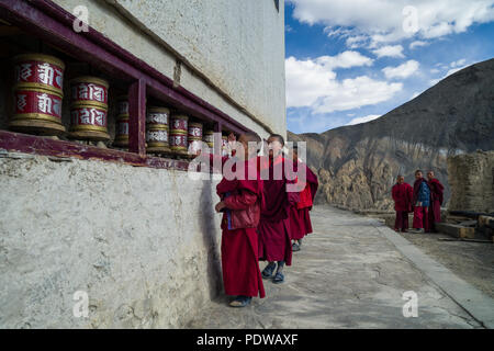 LADAKH, INDIA - MAY 6' 2015: Lillte Tibetan monks rotating praying wheels in the temple. This temple is one of the holiest sites in Tibetan Buddhism. Stock Photo