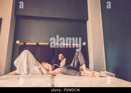 relationship with male and female indoor at home with light window. she pregnant Stock Photo