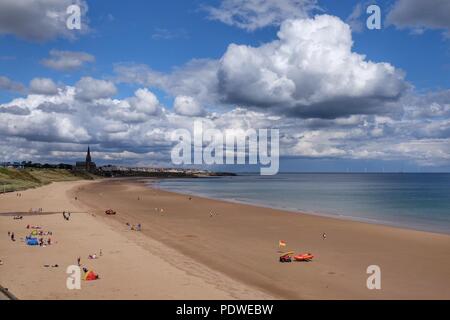 People enjoy the sunshine on the beach at Tynemouth, Tyne and Wear. Stock Photo