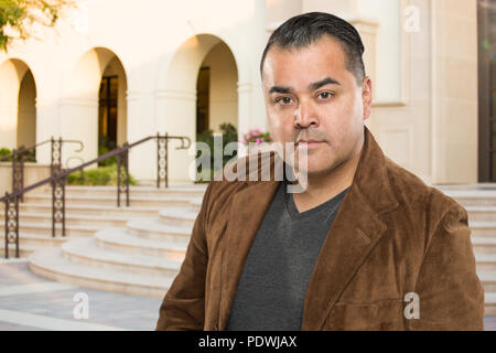 Handsome Young Hispanic Adult Outside of Building. Stock Photo