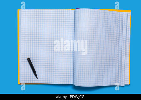 Black used pencil lying on a copybook Stock Photo