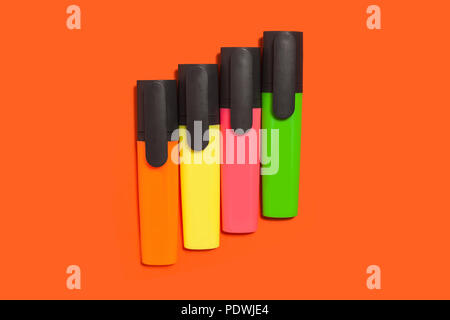 row of markers on an orange background Stock Photo