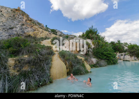 BAGNO VIGNONI - ITALY - CIRCA 2014: People enjoying a natural pool with thermal water in Bagno Vignoni, Tuscany, Italy, Europe Stock Photo