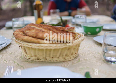 Fresh Homemade Bread in a white basket. Breakfast table. Stock Photo