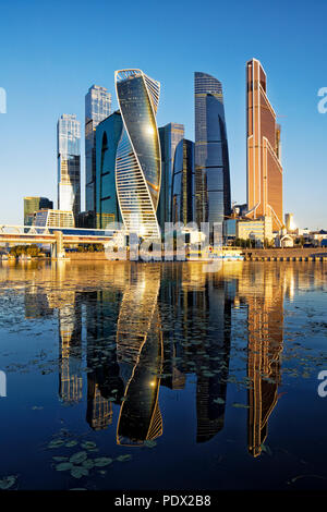 High rise buildings of Moscow International Business Centre (MIBC, or Moscow City) reflected in Moskva River at sunrise. Moscow, Russia. Stock Photo