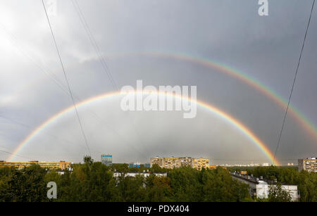 Double rainbow in the sky after summer rain storm on August 7, 2018. Moscow, Russia. Stock Photo