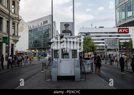 08 August 2018, Germany, Berlin: Numerous people gather at Checkpoint Charlie during the day. At the former border crossing point for diplomats in Berlin, American and Soviet tanks faced each other after the Wall was built 57 years ago. Photo: Wolfgang Kumm/dpa Stock Photo