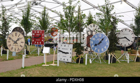 Shrewsbury Flower Show 2018, Shropshire, UK. Display of clocks surrounded by trees. Credit: Susie Kearley/Alamy Live News Stock Photo