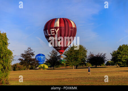 Bristol, UK, 11th August, 2018. Balloons coming in to land after Mass Ascent from Bristol Balloon Fiesta 2018. Credit: Will Dale/Alamy Live News. Stock Photo