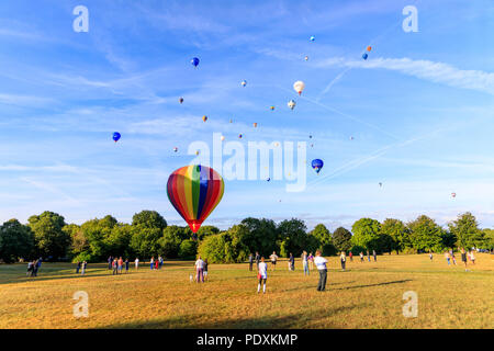 Bristol, UK, 11th August, 2018. Balloons coming in to land after Mass Ascent from Bristol Balloon Fiesta 2018. Credit: Will Dale/Alamy Live News. Stock Photo