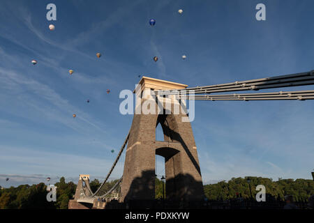 Bristol, UK, 11th August, 2018. Balloons flying over the Clifton Suspension Bridge after the first Mass Ascent from Bristol Balloon Fiesta 2018. Credit: Steve Davey/Alamy Live News. Stock Photo
