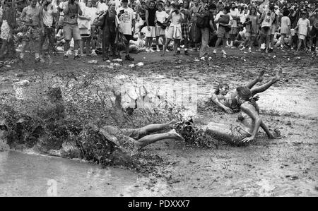 Group of People Sliding in Mud during Woodstock Music Festival, Saugerties, New York, USA, July 13, 1994 Stock Photo