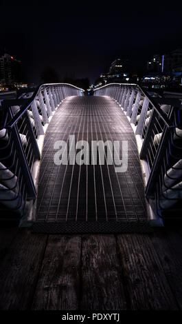 Small pedestrian bridge at night in False Creek, Vancouver Stock Photo ...