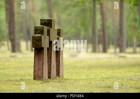 Three stone crosses in the military cemetery, Waldfriedhof Halbe, one of the largest war graves sites in Germany for 28,000 Stock Photo