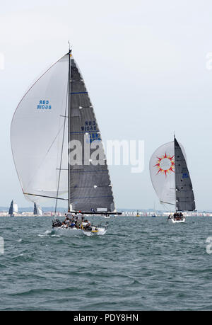 Sailing yachts Oui and Jua Kali on the downwind leg of  an IRC class 2 race in the Solent during Cowes Week regatta Stock Photo