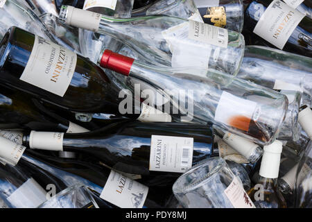 Close-up of empty glass wine bottles from Domaine Lazzarini collected for recycling in Patrimonio, Corsica, France, displaying regional wine labels. Stock Photo