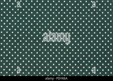 Dark green fabric background with white polka dot pattern. Stock Photo