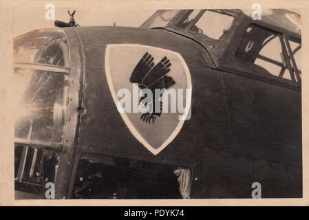 Image from the photo album of Feldwebel Willi Hoffmann of 5. Staffel, Kampfgeschwader 30: The famous black diving eagle on a red shield emblem of II. Gruppe, KG 30 adorns the nose of a Junkers Ju 88A-1 of 5./KG 30 in the summer of 1940. Stock Photo