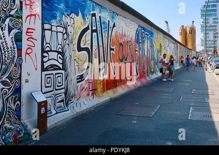 East Side Gallery - Painted and graffitied remains of the Berlin Wall in Friedrichshain, Berlin, Germany. Hot summer afternoon in August 2018. Stock Photo