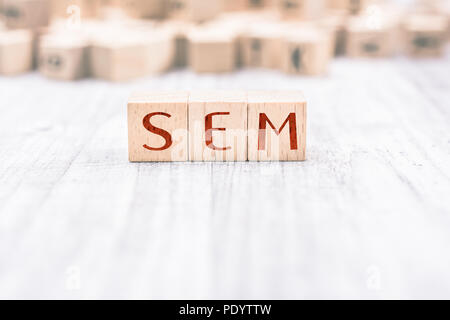 The Word SEM Formed By Wooden Blocks On A White Table Stock Photo