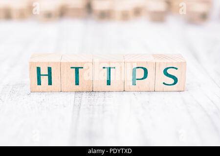 The Word HTTPS Formed By Wooden Blocks On A White Table Stock Photo