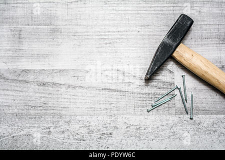 Tool Set Of Hammer And Nails On A Wooden Table - Top Down View With Copy Space Stock Photo