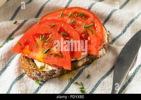 Trendy Homemade Tomato Toast with Goat Cheese and Chives Stock Photo