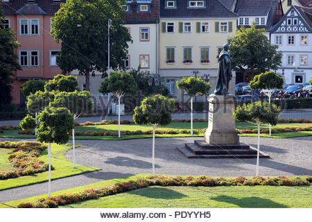 A view of a section of Castle Square (Schlossplatz) in the Franconian town of Coburg, Germany on a sunny day with shadows and a statue to Ernst I. Stock Photo