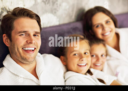 Happy family relaxing in hotel room Stock Photo