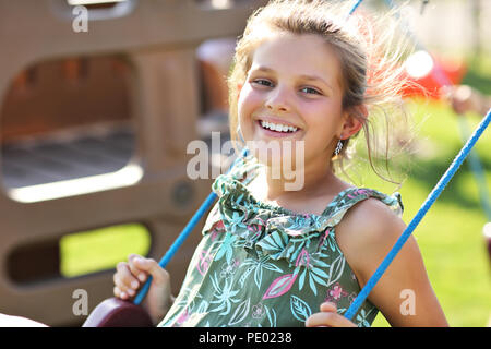Joyful girl having fun on playground Stock Photo