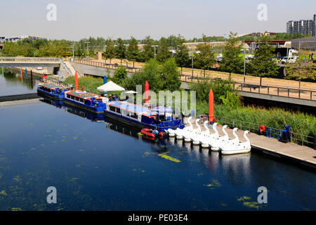 Pleasure trip boats and swan pedallo's moored on the Waterworks River, Queen Elizabeth Olympic Park, Stratford, London, England Stock Photo