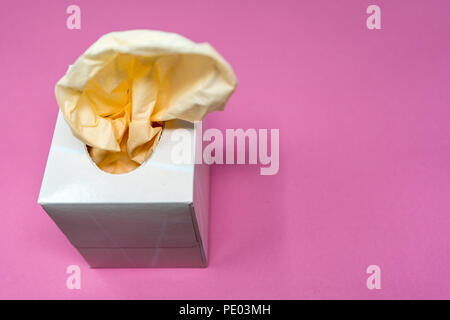 Facial Tissue Cube Box. Peach colored tissue paper. Stock Photo