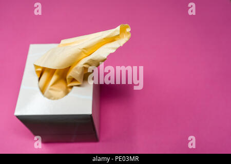 Facial Tissue Cube Box. Peach colored tissue paper. Stock Photo
