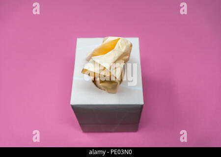 Facial Tissue Cube Box. Peach colored tissue paper. Stock Photo