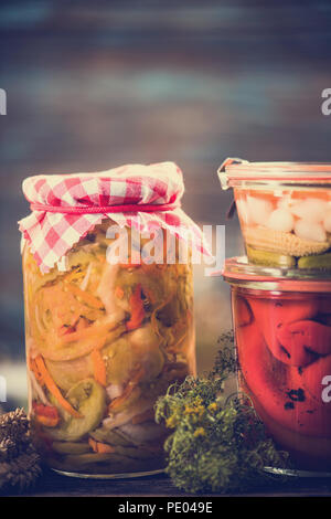 Pickled and Marinated fermented raw vegetables salad in jar Stock Photo